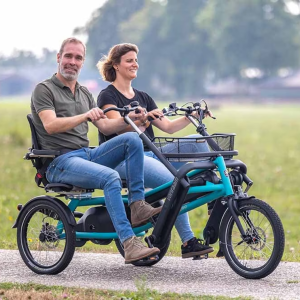 A couple riding side by side on their VanRaam Fun2Go, while smiling
