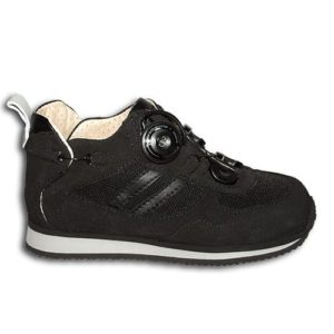 A black shoe with a cream-coloured lining and a small device on the front, and joins in the heels, to lace it up.