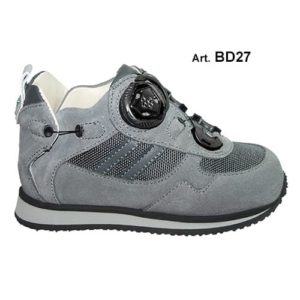 A small grey shoe with a cream-coloured lining and a small device on the front, and joins in the heels, to lace it up.