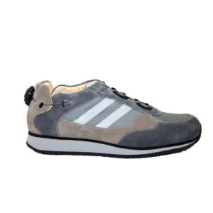 A grey and brown shoe with a cream-coloured lining and a small device on the back to lace it up.