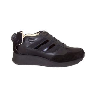 A black shoe with a cream-coloured lining and a small device on the front, and joins in the heels, to lace it up.