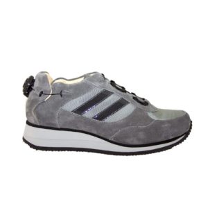 A grey shoe with a cream-coloured lining and a small device on the back to lace it up.
