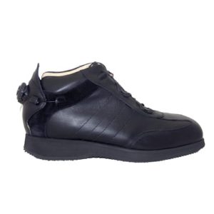 A black shoe with a cream-coloured lining and a small device on the back to lace it up.