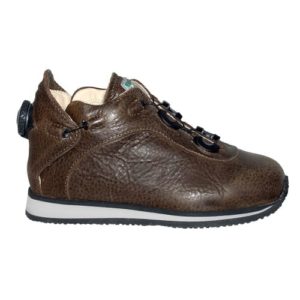 A small brown shoe with a cream-coloured lining and a small device on the back to lace it up.