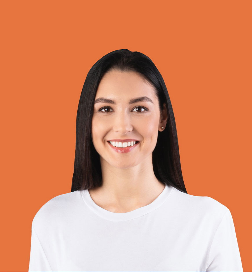 An image in profile of a white woman on an orange background. She has long black hair and is wearing a white t-shirt.