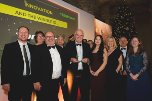 The Tomcat Team on stage collecting their award for Innovation.