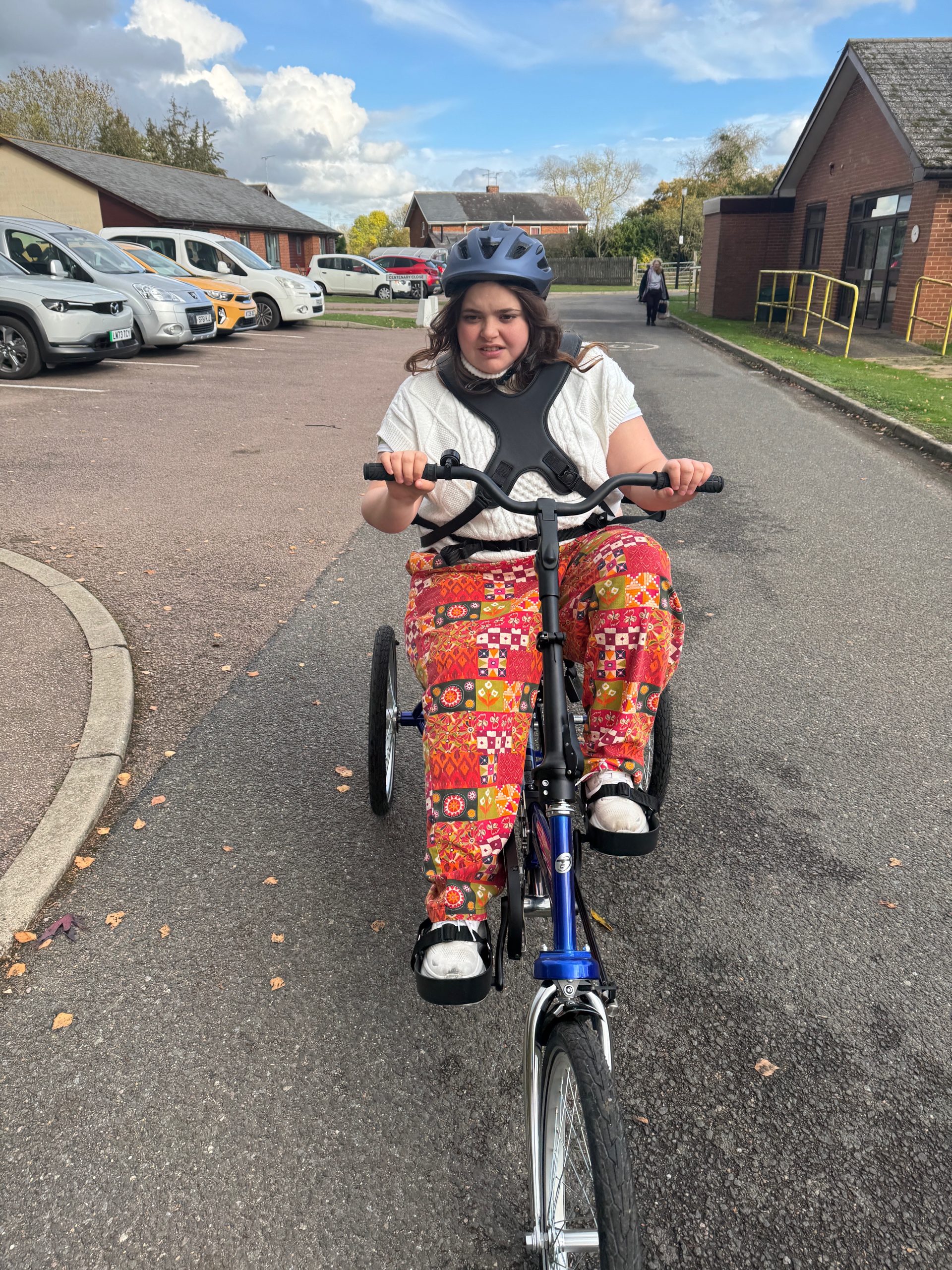 Sapphi riding her Tomcat Appentice Bullet down a road.
